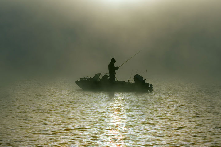 fisherman silhouette on a foggy Georgia morning