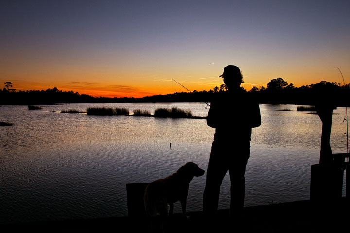 fisherman and dog silhouette - South Carolina sunset